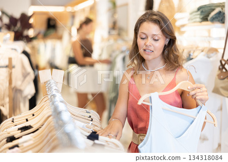 European woman chooses tank top European woman chooses tank top 134318084