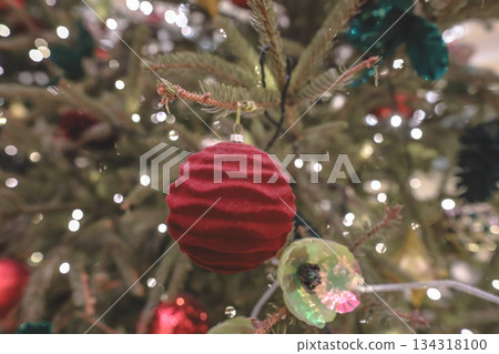 Festive Christmas tree glowing warmly in holiday ambiance Festive Christmas tree glowing warmly in holiday ambiance 134318100