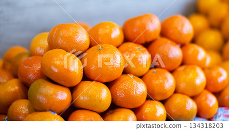 Ripe tangerines in a box on the market close up 134318203