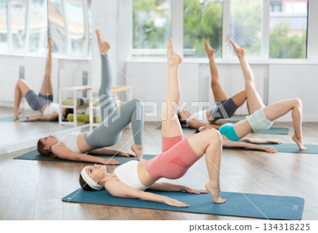During training girl leads women class, performs variety of exercises to strengthen muscles of press During training girl leads women class, performs variety of exercises to strengthen muscles of press 134318225