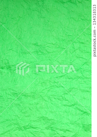 vertical background of crimped crepe paper in bright lime green 134318313