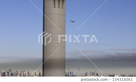 View of the city center including Tokyo Skytree from the observation deck of Haneda Airport's Terminal 1, and a plane taking off 134318361