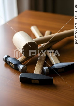 Wooden and Metal Hammers on Polished Table Wooden and Metal Hammers on Polished Table 134318380