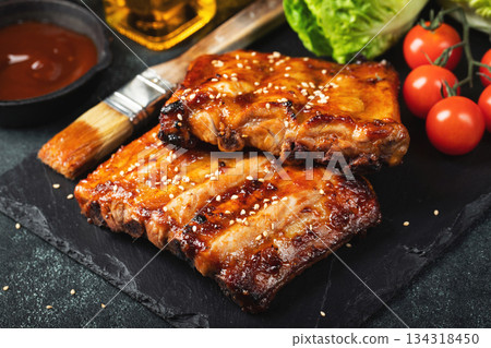 Barbecue pork spare ribs with hot honey chili marinade on black background Barbecue pork spare ribs with hot honey chili marinade on black background 134318450