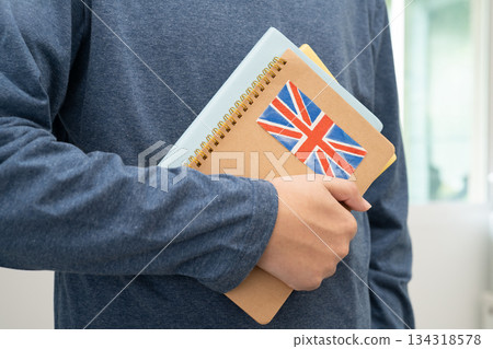 Learn English language, Asian teenage student hold book with flag in course at school. Learn English language, Asian teenage student hold book with flag in course at school. 134318578