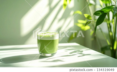 Relaxing cafe time: A matcha latte with beautiful latte art and a table bathed in gentle light 134319049