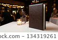 table setting in restaurant with leather menu book 134319261