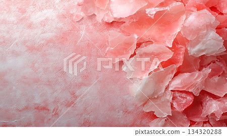 Pink Himalayan salt crystals scattered on a textured surface for culinary or spa use 134320288