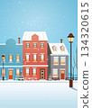 Christmas snowy city houses winter street scene colorful buildings snow falling trees lampposts blue sky seasonal holiday background 134320615