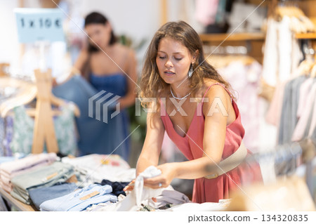 Girl customer chooses shorts in store 134320835