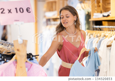 woman chooses a blouse for a profitable promotion 134320853