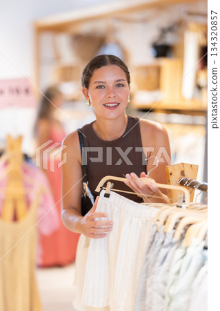 Girl customer chooses shorts in store Girl customer chooses shorts in store 134320857