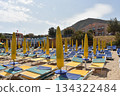 Mediterranean beach and closed parasols 134322484