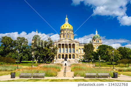 Iowa State Capitol building stands on a hill in Des Moines, USA. Historic architecture features a central golden dome and four corner domes under a blue summer sky Iowa State Capitol building stands on a hill in Des Moines, USA. Historic architecture features a central golden dome and four corner domes under a blue summer sky 134322768