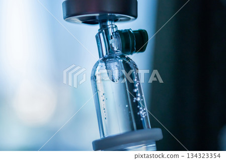 Close up medical intravenous IV drip in hospital background Close up medical intravenous IV drip in hospital background 134323354