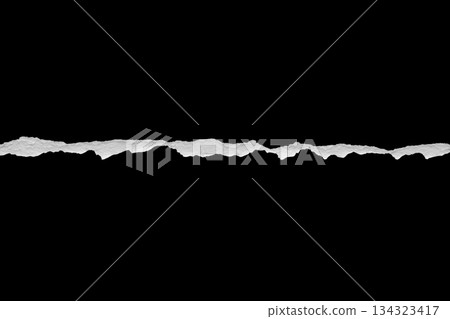 Ripped torn paper edges isolated on black background Ripped torn paper edges isolated on black background 134323417
