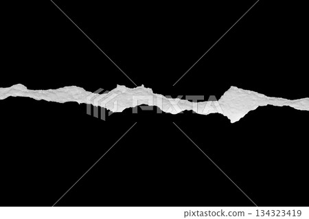 Ripped torn paper edges isolated on black background Ripped torn paper edges isolated on black background 134323419