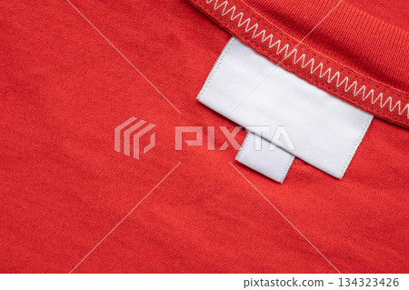 White blank laundry care clothes label on shirt fabric background 134323426