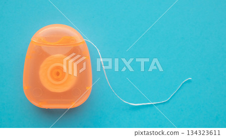 dental floss in case on blue background 134323611