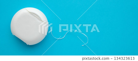dental floss in case on blue background 134323613