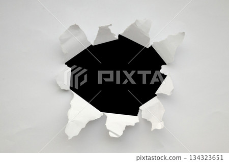 Torn ripped paper hole isolated on black background Torn ripped paper hole isolated on black background 134323651