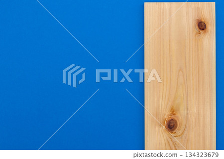 Beautiful wood grain and knots (cypress board) placed on a vivid blue background. Image of DIY, architecture, material Beautiful wood grain and knots (cypress board) placed on a vivid blue background. Image of DIY, architecture, material 134323679