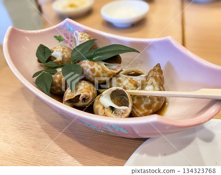 A simmered dish of clams with the meat removed from the shell. 134323768