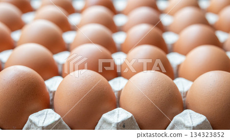 Fresh organic brown chicken eggs in cardboard tray 134323852
