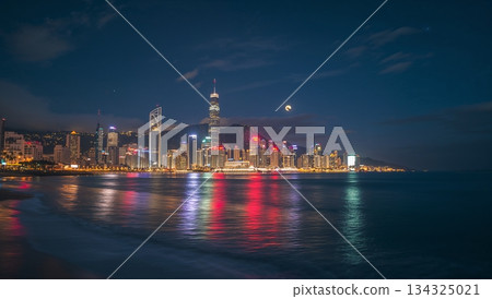 A city skyline is reflected in the water at night 134325021