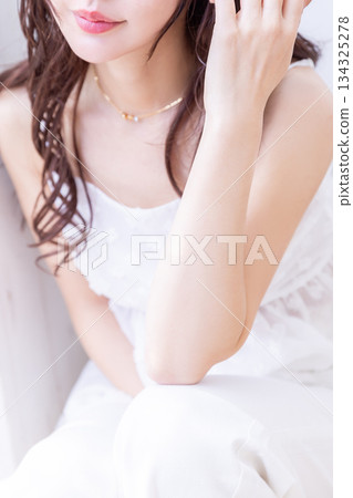 A beautiful woman with curly hair wearing loungewear 134325278