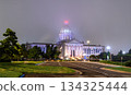 Night view of Oklahoma State Capitol in Oklahoma City. Neoclassical building features illuminated dome and columns amidst foggy atmosphere 134325444