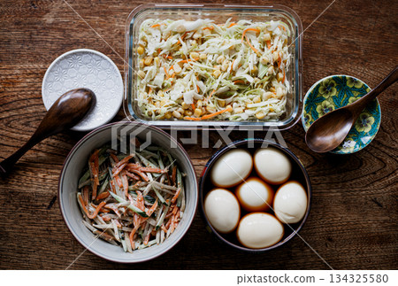 Three homemade side dishes: coleslaw, burdock salad, and seasoned egg Three homemade side dishes: coleslaw, burdock salad, and seasoned egg 134325580