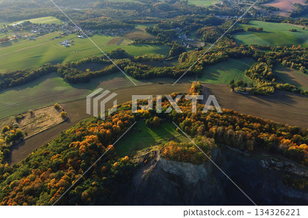 Autumn forest on cliff with rural fields in aerial landscape Autumn forest on cliff with rural fields in aerial landscape 134326221