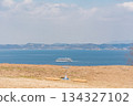 Sea, sky, boat and bench 134327102
