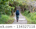 Back view of climbing woman 134327118