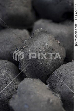 charcoal compressed from crumbs is obtained under pressure and used to light a fire and cook food on the grill, black charcoal in briquettes for grills charcoal compressed from crumbs is obtained under pressure and used to light a fire and cook food on the grill, black charcoal in briquettes for grills 134327363
