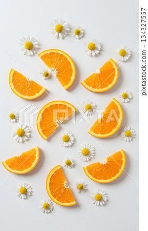Fresh Orange Slices and Daisy Flower Pattern on White Background 134327557