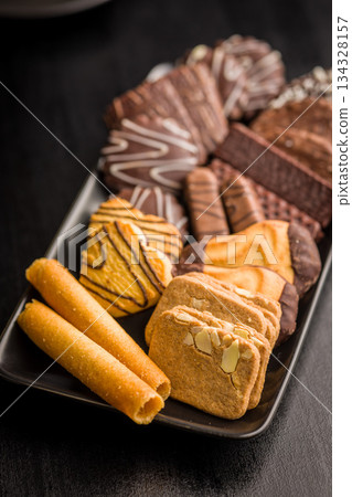 Christmas sweet and cookies on plate on black table. Christmas sweet and cookies on plate on black table. 134328157