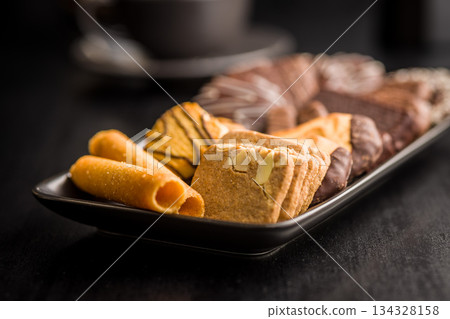 Christmas sweet and cookies on plate on black table. Christmas sweet and cookies on plate on black table. 134328158