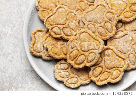 Homemade paw print dog treats on a plate 134328575