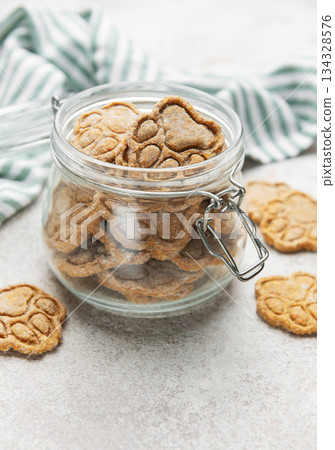Homemade dog paw print treats in jar Homemade dog paw print treats in jar 134328576