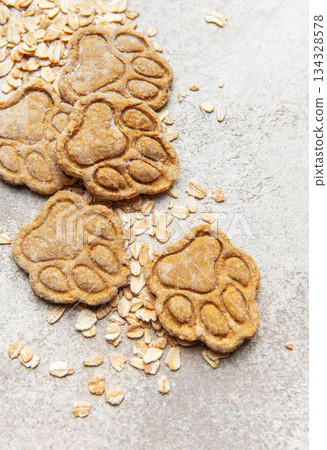 Homemade oat dog treats shaped as paw prints 134328578