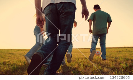 Parents run with child kid playing football green lawn, children kicking ball, mother father girl boy happy family sunset, simple happiness., love, connection., lifestyle, parenting tips, health 134328605