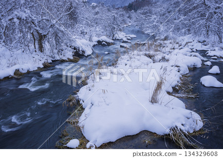 Snow piled river 134329608