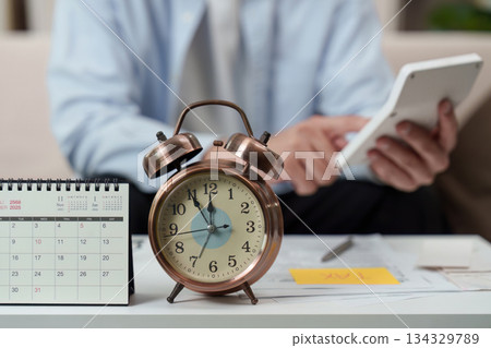 Time Management. Individual planning tasks with calendar and alarm clock on desk. Time Management. Individual planning tasks with calendar and alarm clock on desk. 134329789