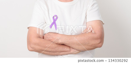 Elderly woman with light Purple Ribbon for All cancer, April Esophageal Cancer, January Thyroid disease, September Hodgkin Lymphoma, Awareness month and February World cancer day concepts 134330292