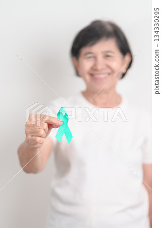 Elderly with Teal Ribbon for September Ovarian Cancer Awareness month, PCOS, January Cervical Cancer, April Sexual Assault, June PSTD, Post Traumatic Stress Disorder, May Tourette syndrome 134330295