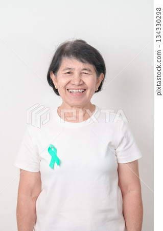 Elderly with Teal Ribbon for September Ovarian Cancer Awareness month, PCOS, January Cervical Cancer, April Sexual Assault, June PSTD, Post Traumatic Stress Disorder, May Tourette syndrome 134330298