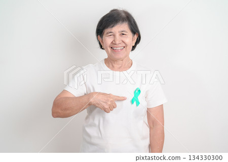 Elderly with Teal Ribbon for September Ovarian Cancer Awareness month, PCOS, January Cervical Cancer, April Sexual Assault, June PSTD, Post Traumatic Stress Disorder, May Tourette syndrome Elderly with Teal Ribbon for September Ovarian Cancer Awareness month, PCOS, January Cervical Cancer, April Sexual Assault, June PSTD, Post Traumatic Stress Disorder, May Tourette syndrome 134330300