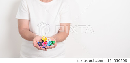 World cancer day, February 4. Elderly with colorful ribbons, blue, yellow, red, green, white, pink and grey for supporting people living and illness. Health, Medical, awareness and Insurance concept 134330308